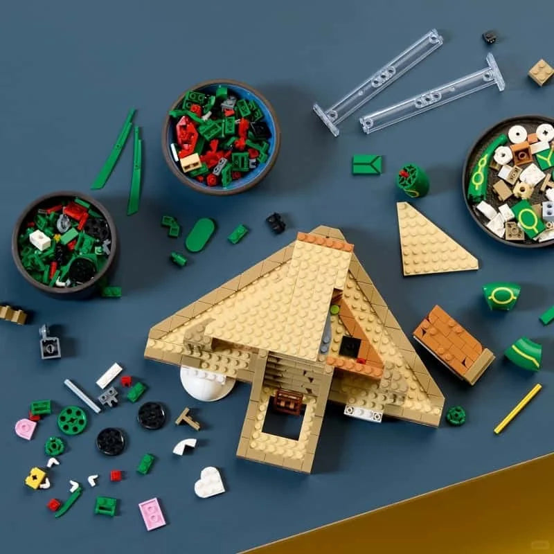 Tan brick build with A-frame house, green base pieces, and accessories