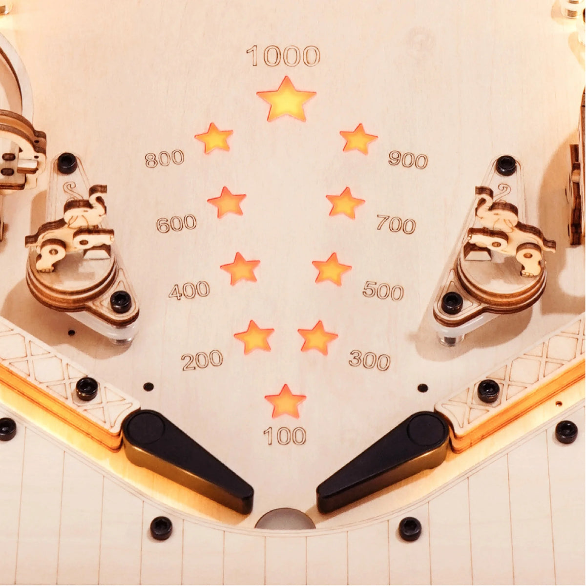 Wooden pinball machine playfield close-up with star targets and numbered sections