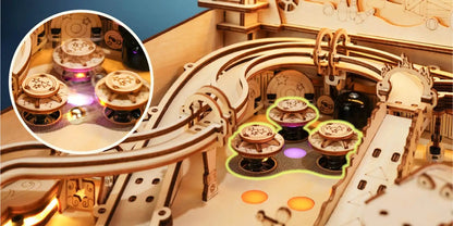 Wooden pinball machine interior close-up with glowing purple scoring wheels