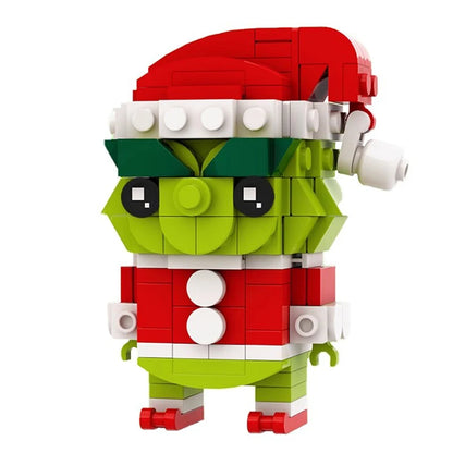 Brick-built Grinch-like face with red Santa hat, green head, white beard and black eyes