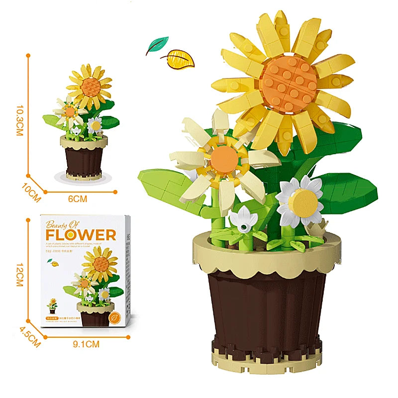 Yellow sunflower flower building blocks in a dark brown pot with green leaves, with box