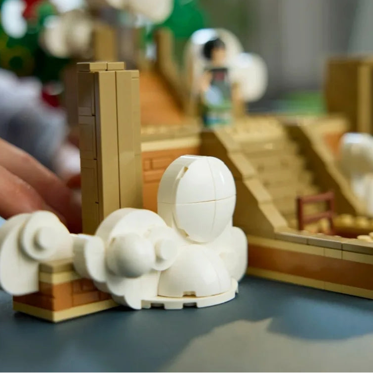 Buildable dragon base with tan structure and white cloud-like dome pieces in front