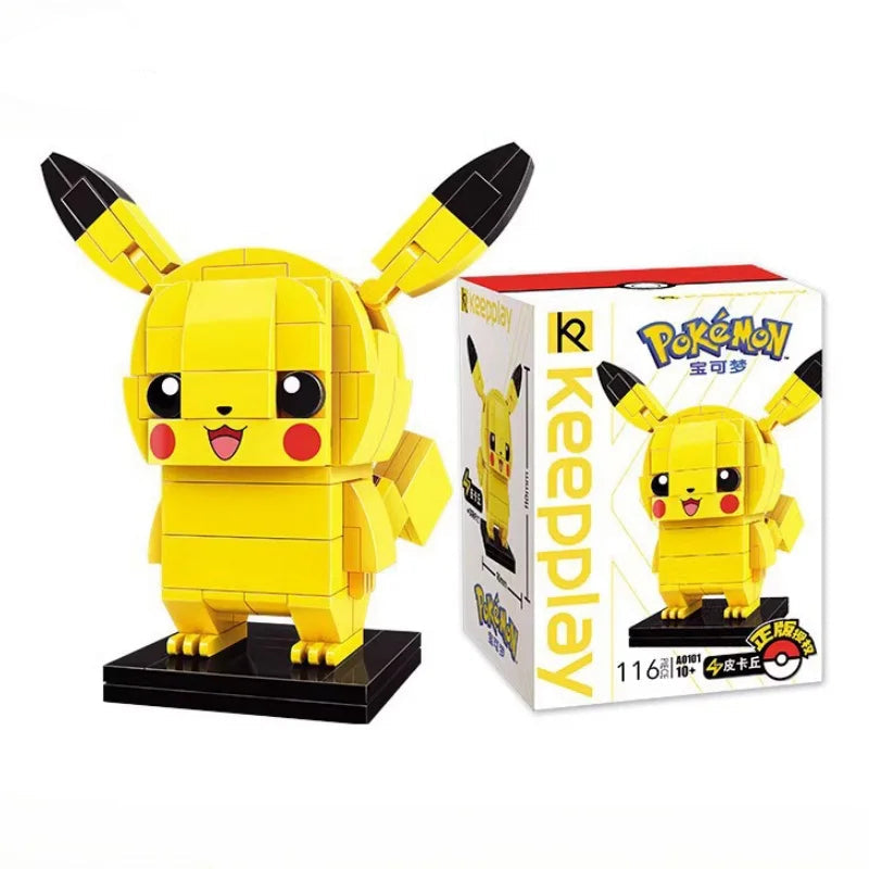 Pikachu brick building figure with black-tipped ears on a black base beside its box