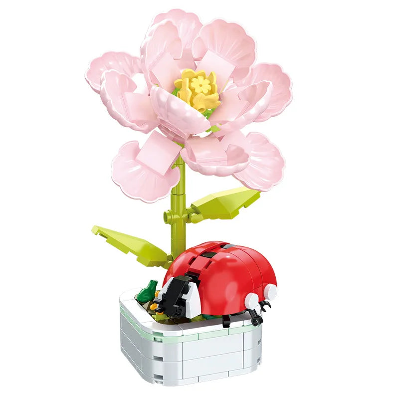 Pink flower and red ladybug building set on white block planter