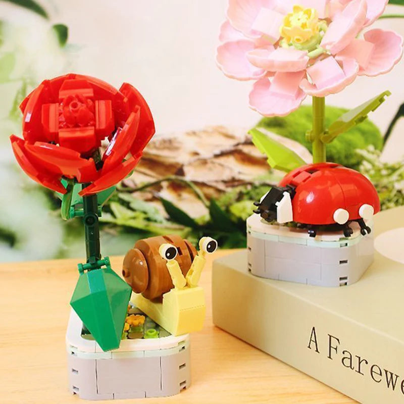 Red ladybug and garden flower building set on white block planter