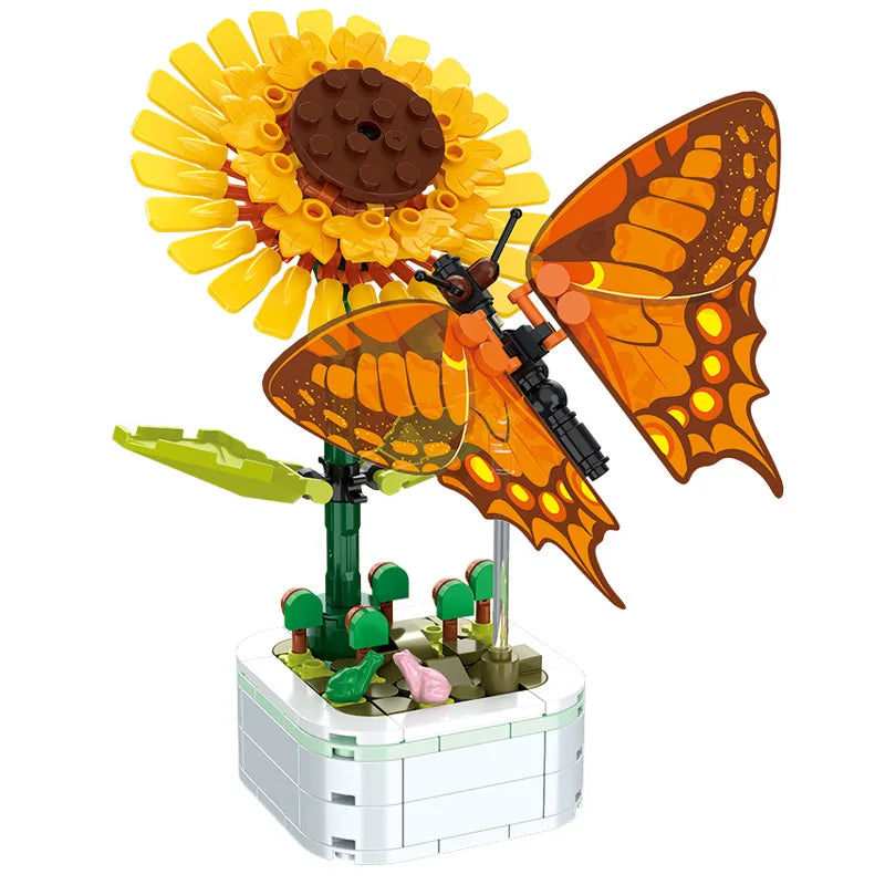 Orange butterfly building set with green stem and yellow flower on white block base