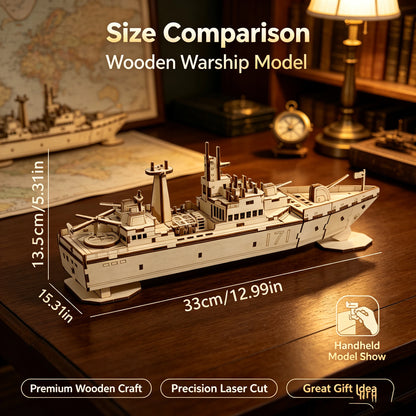 White wooden warship model kit with stacked decks and radar towers, placed on tabletop
