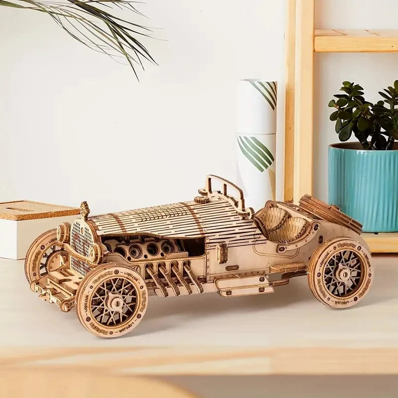 Wooden Grand Prix race car model displayed with spoked wheels and side panels.