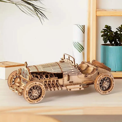 Wooden Grand Prix race car model displayed with spoked wheels and side panels.