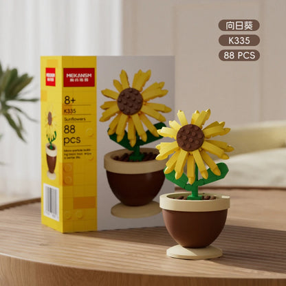 Sunflower flower building blocks in a brown pot with green stem and leaves, with box