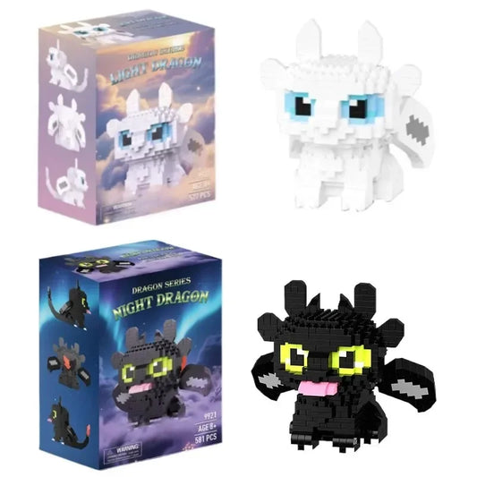 Brick-built dragon figure set: white Light Fury and black Toothless, with retail boxes
