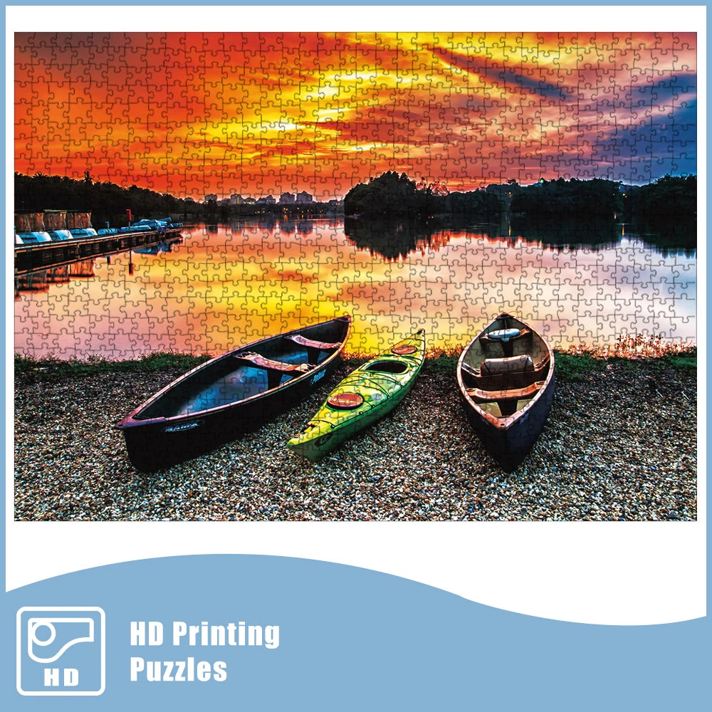 Assembled 1000-piece puzzle showing three kayaks by a lake beneath a colorful sunset