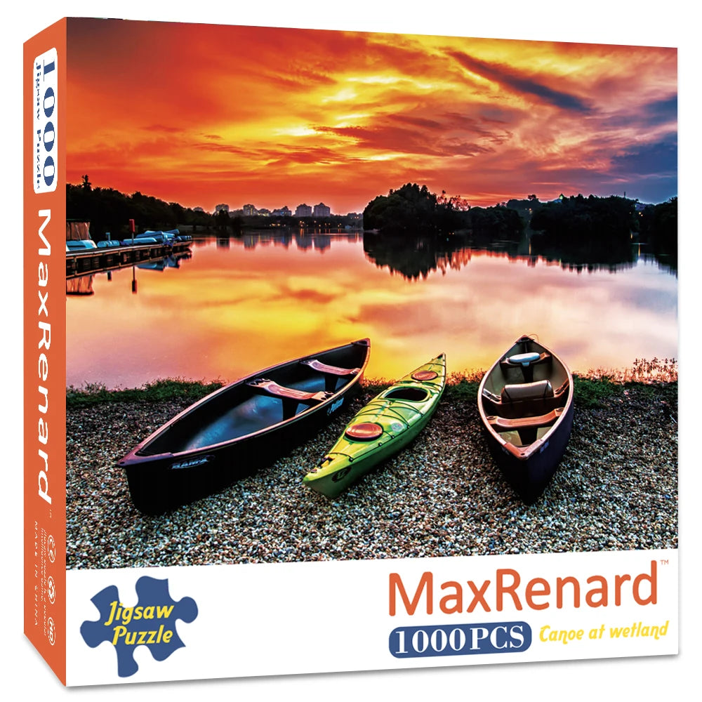 1000-piece Sunset Kayaks landscape jigsaw puzzle box featuring three kayaks by a sunset lake