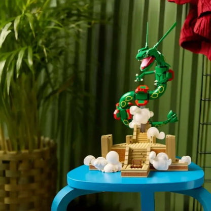 Green dragon figure posed on tan base with white cloud parts, set on a blue platform