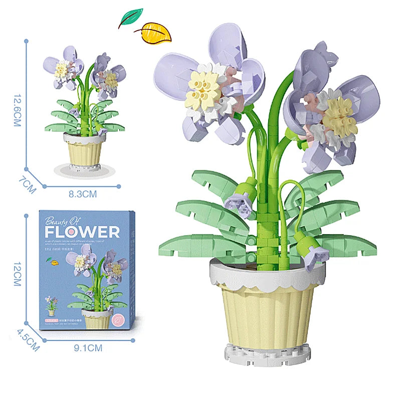 White and purple blossom flower building blocks in a beige pot with green leaves, with box