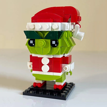 Brick-built Grinch-like character figure with red Santa hat, green face, black eyes